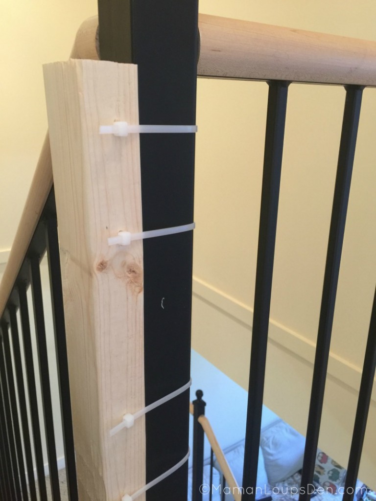 Wood attached to banister with zip ties