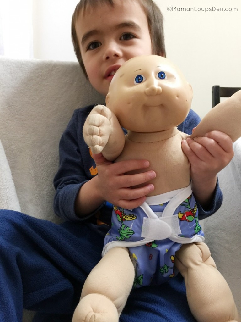 Cub displays a diapered doll