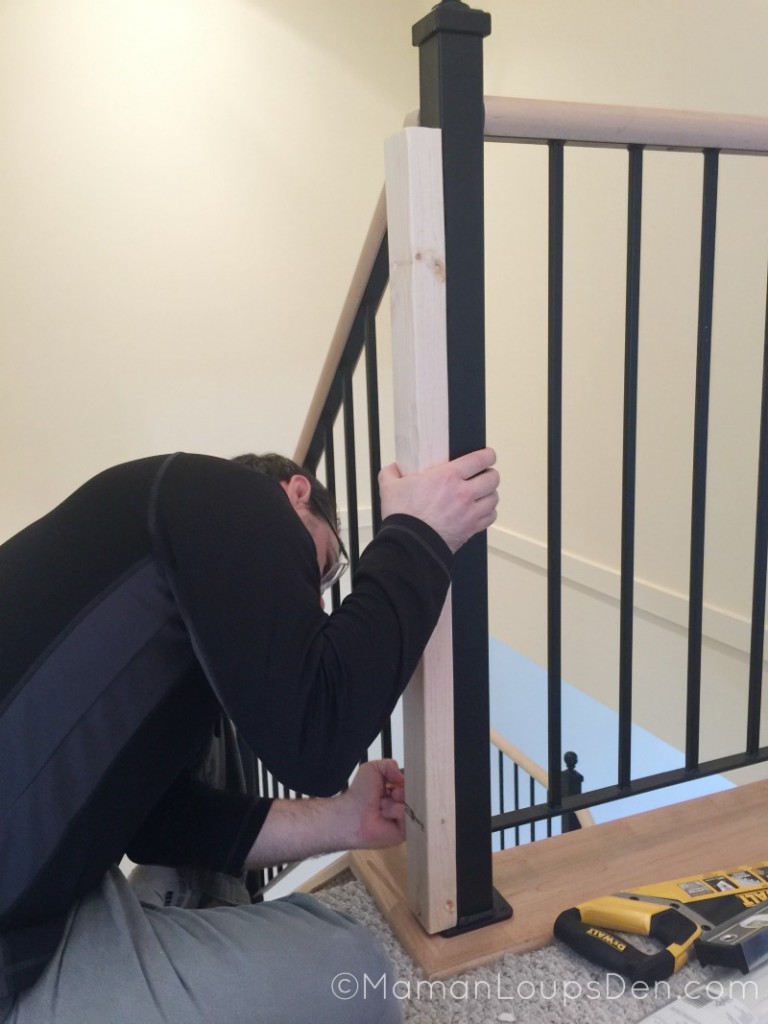 Measuring a piece of wood to attach to our banister